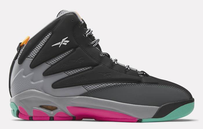 Side view of a black, grey, and pink Reebok shoe.